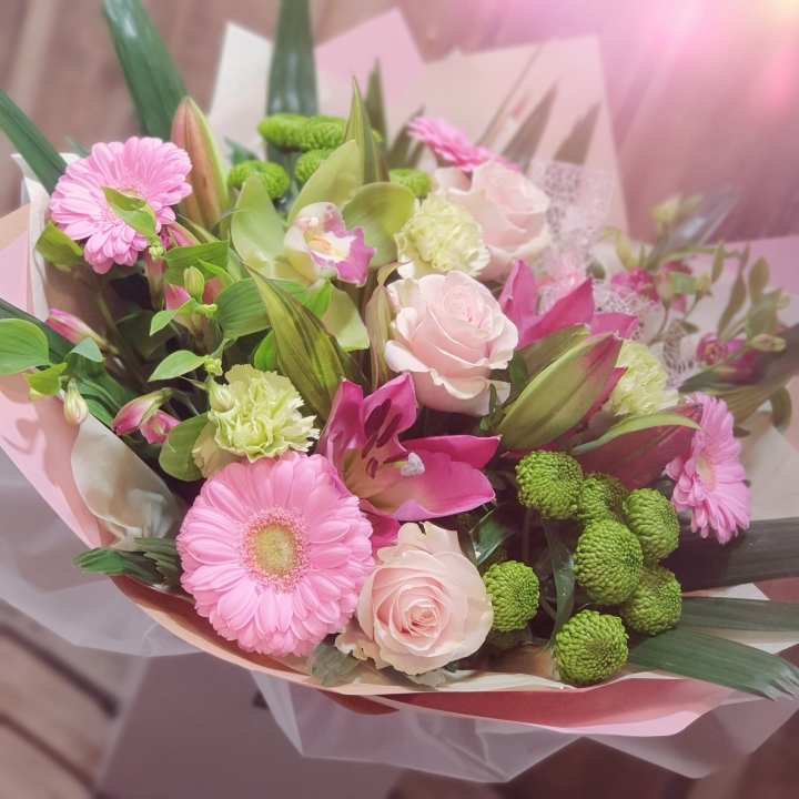 Pink bouquet of roses, lilys and other flowers